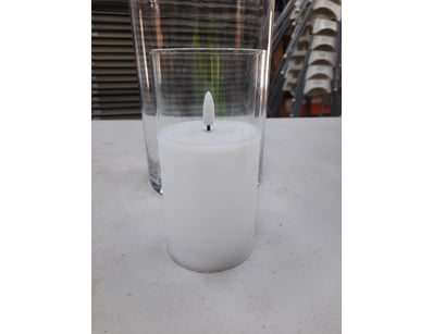 Candle in glass container.

