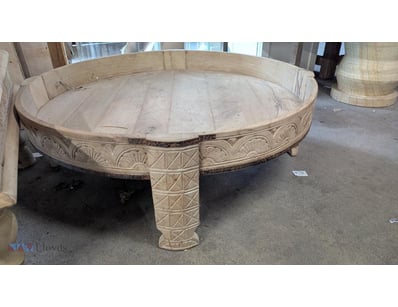 Wooden coffee table featuring a large Circular top...