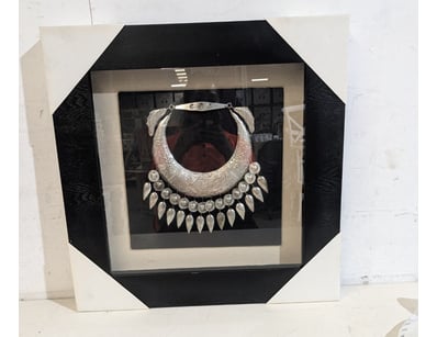 Exquisite silver ceremonial necklace displayed in ...