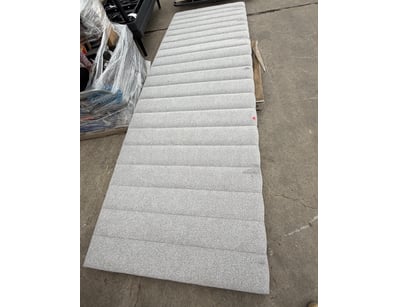Grey upholstered vertical-channel tufted headboard...