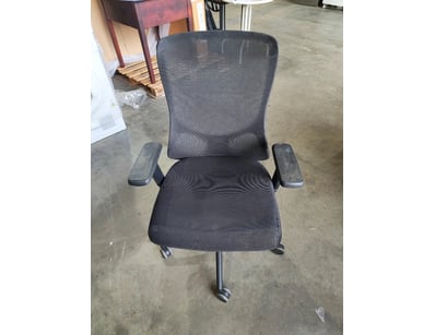 Black mesh office chair featuring ergonomic design...