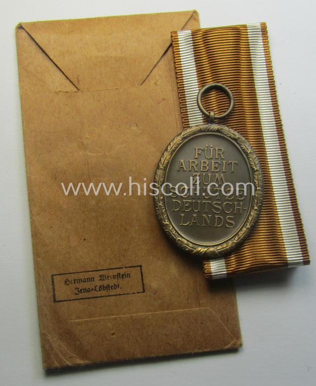 Medal-set: 'Deutsches Schutzwall Ehrenzeichen' (aka: 'Westwall'-medal) being a (typical) non-maker-marked- and/or: typical 'Buntmetall'-based specimen that comes packed in its original pouch of issue by the: 'Hermann Wernstein'-company