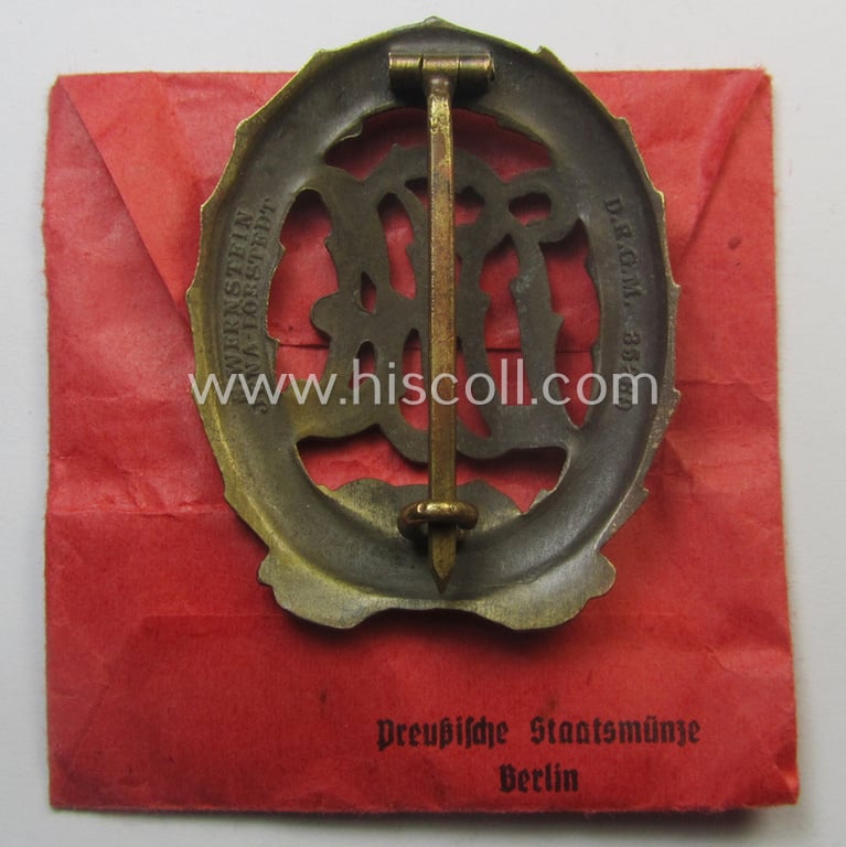 'Reichssportabzeichen DRL in Bronze' by: 'Wernstein' that came stored in its (unusally seen!) red-coloured (and maker- ie. 'Preussische Staatsmünze - Berlin'-marked pouch as issued and found