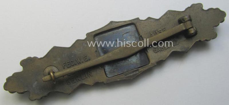 'Nahkampfspange in Bronze' (or: bronze-class close-combat clasp ie. CCC) being a maker- (ie. 'A.G.M.u.K.'-) marked- and/or minimal converse-shaped specimen having its period-attached (bluish-toned and steel-based) 'back-plate' in place