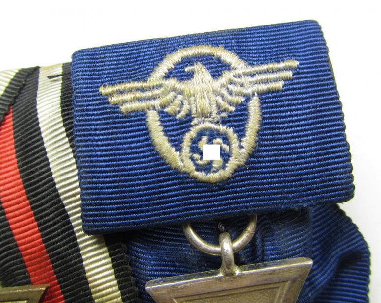 Two-pieced medal-bar (ie. 'Doppelspange') respectively depicting a WWI-period: 'Frontkämpferkreuz 1914-18' (ie.: 'Kriegsteilnehmerkreuz mit Schwerter') and a detailed: 'Polizei-Dienstauszeichnung 2. Stufe'