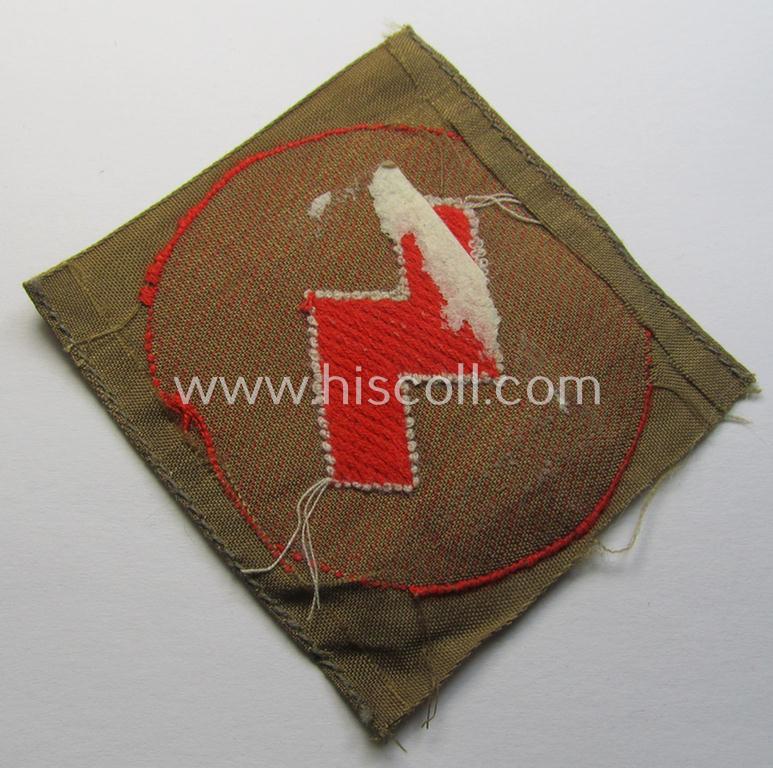 Attractive, DJ (ie. 'Deutsches Jungvolk') arm-badge as was intended for usage by a member who served within the: 'Oberbann 1' (being a 'virtually mint- ie. unissued' example that still shows the remains of its 'RzM'-etiket)