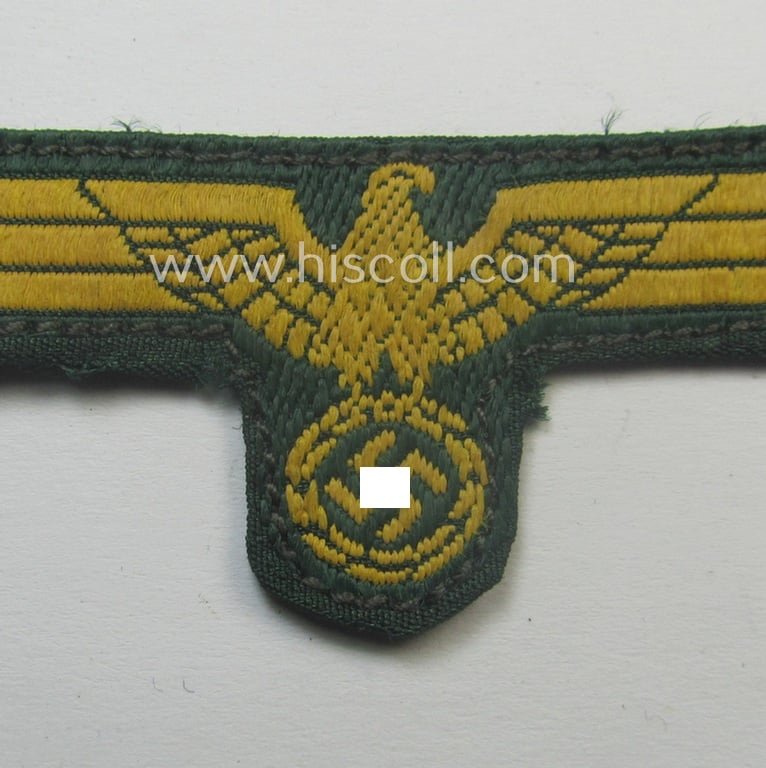 Moderately used- and/or carefully cap-removed, WH (Kriegsmarine o. Küsten-Artillerie) 'BeVo'-weave pattern side-cap-eagle onto a darker-green-coloured background
