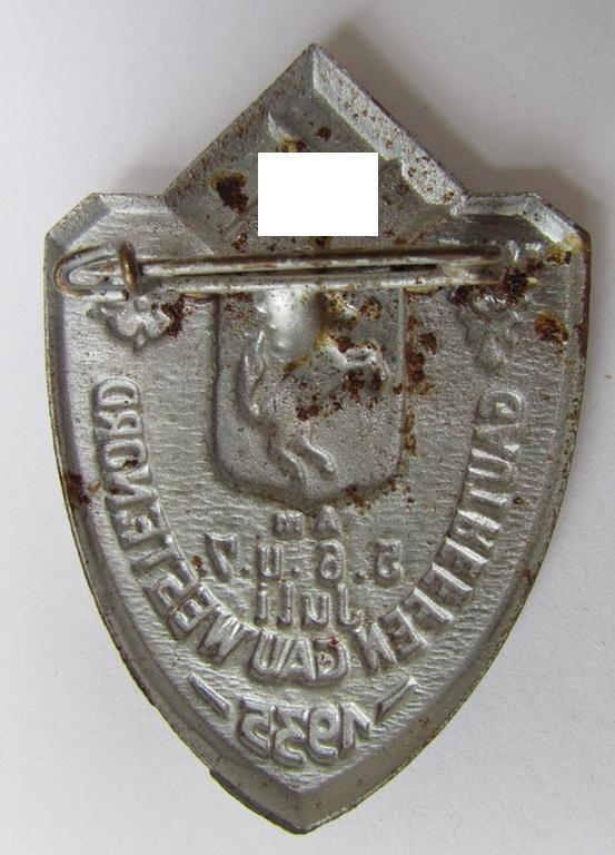 Commemorative, silver-coloured N.S.D.A.P.-related day-badge (ie. 'Veranstaltungsabzeichen' or: 'tinnie') being a non-maker-marked example depicting a provincial-armshield surrounded by the text: 'Gautreffen Gau Westf. Nord - 5.6.u.7. Juli 1935'