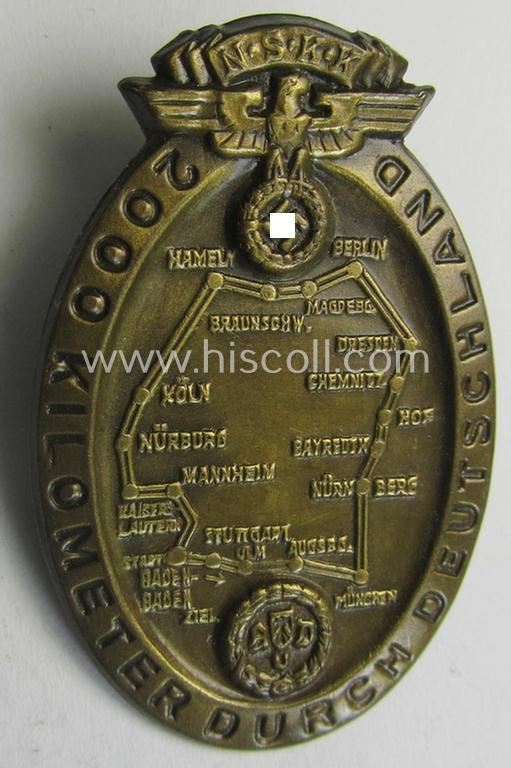 Commemorative - golden-bronze-toned- and fairly unusually seen! - N.S.K.K.-related 'tinnie' being a non-maker-marked example depicting an illustration of an N.S.K.K.-logo and map of Germany coupled with the text: '2000 Kilometer durch Deutschland...