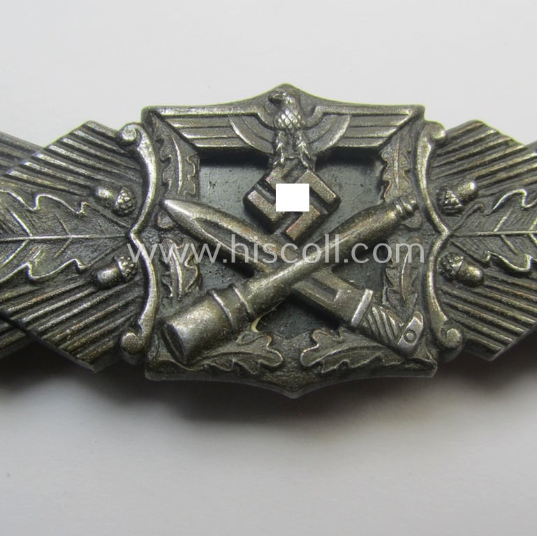 'Nahkampfspange in Bronze' (or: bronze-class close-combat clasp ie. CCC) being a neatly maker-marked- and/or minimally converse-shaped specimen as was produced by the: 'JFS'- (ie. 'Joseph Feix u. Söhne'-) company