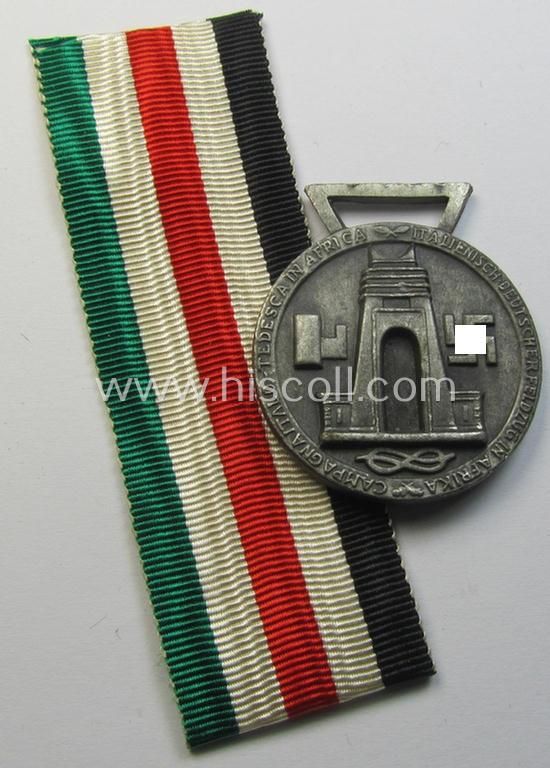Superb, silver-coloured- (and I deem 'Feinzink'-based-) example of a: 'Deutsch-Italienische Feldzugsmedaille' (or: German-Italian campaign medal) that came together with its (regular-sized) piece of original ribbon