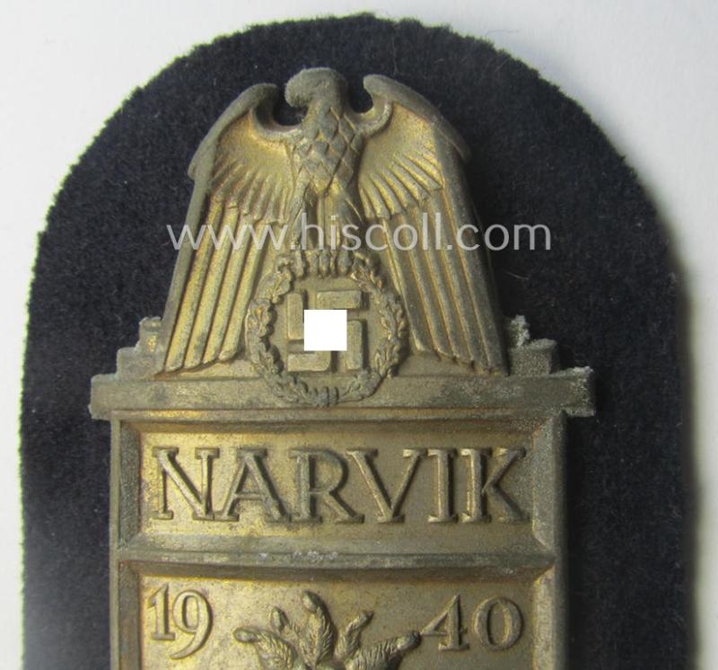 WH (Kriegsmarine) 'Narvik'-campaign-shield being a detailed example as executed in (light) golden-toned zinc- (ie. 'Feinzink') and that comes in an issued- (and/or moderately worn- ie. once tunic-attached-), condition