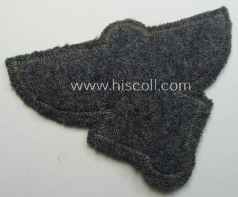 Bluish-grey-coloured, so-called: N.S.F.K.- (or: 'National Socialistisches Flieger Korps') breast-badge being a nicely BeVo-woven- (and enlisted-mens'-pattern) example that comes mounted on its piece of bluish-coloured wool