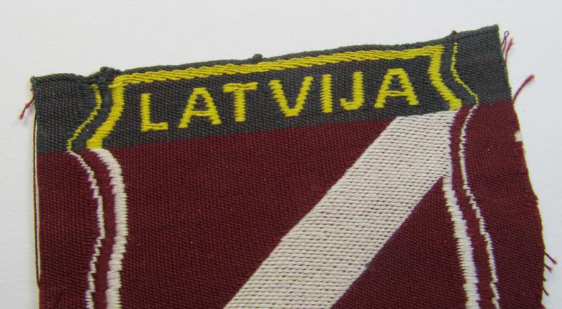Superb - and truly rarely seen! - locally produced(!), 'Waffen-SS'-type armshield as executed in the so-called: 'semi-BeVo'-pattern entitled: 'Latvia' as was merely intended for usage by the members of the: 'Latvian Legion'