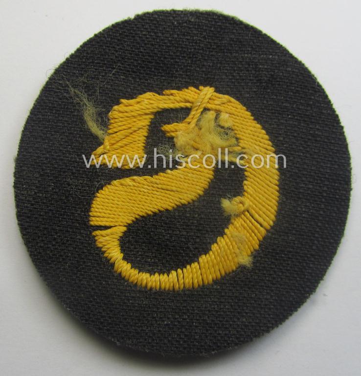 WH (Heeres) so-called: trade- and/or special-career arm-insignia (ie. 'Laufbahn- o. Tätigkeitsabzeichen') as intended for a: 'Schirrmeister' (being a neatly hand-embroidered variant as mounted onto a field-grey-coloured- and woolen-based backgrou...