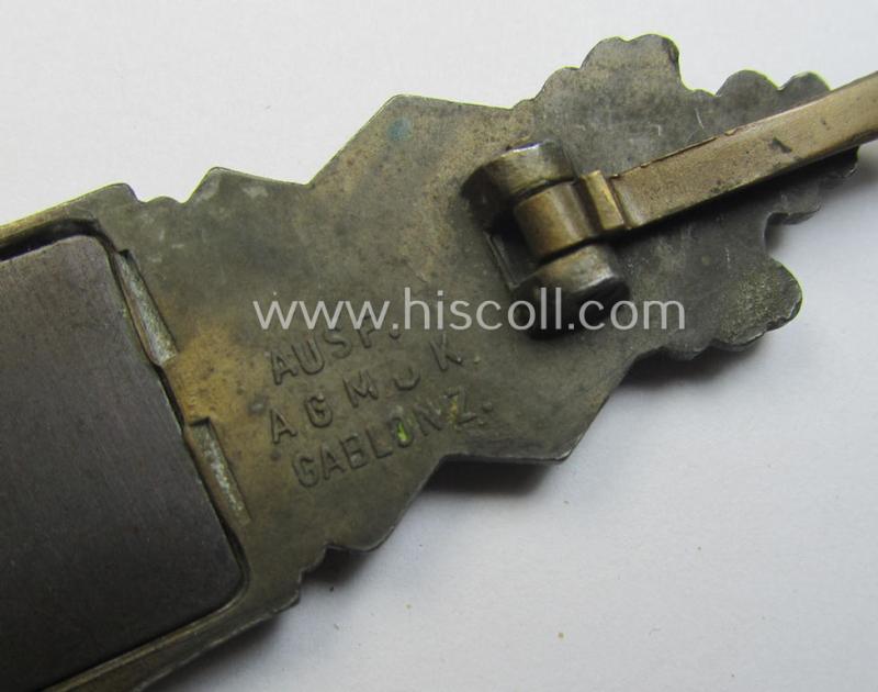 'Nahkampfspange in Bronze' (or: bronze-class close-combat clasp ie. CCC) being a maker- (ie. 'A.G.M.u.K.'-) marked- and/or minimal converse-shaped specimen having its period-attached (steel-based) 'back-plate' in place