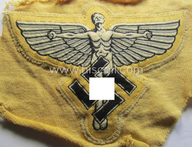 Very unusual, bright-yellow-coloured: N.S.F.K.- (or: 'National Socialistisches Flieger Korps') sports-shirt breast-eagle being a nicely 'BeVo'-woven- (and carefully 'cut-out'!) example that comes still mounted onto its piece of a period shirt