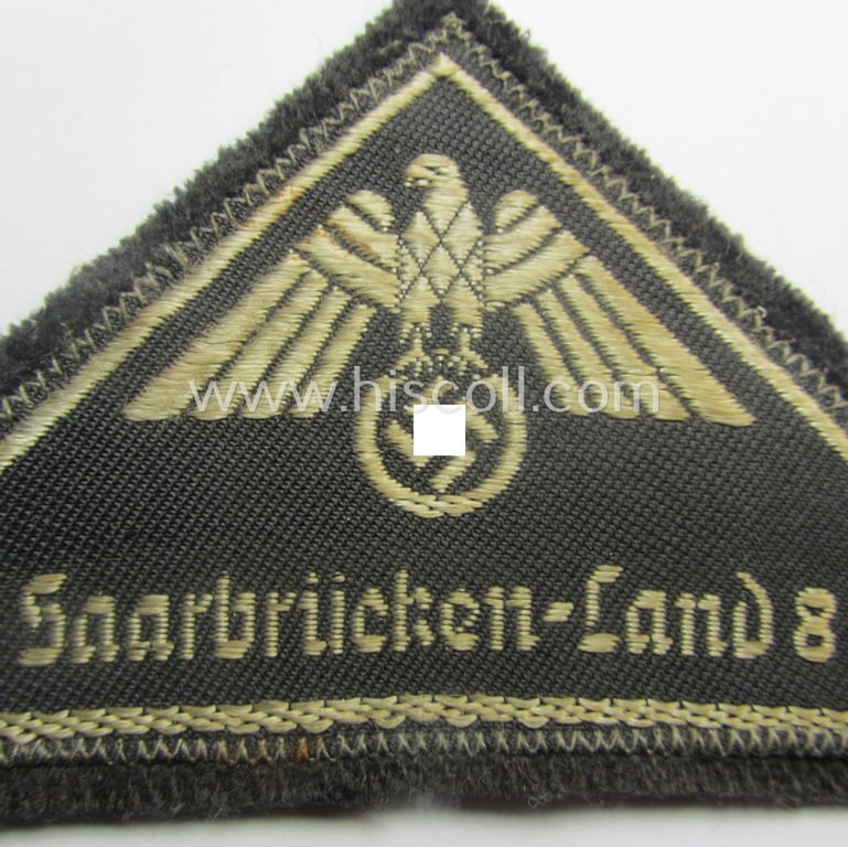 German Red Cross (ie. 'Deutsches Rotes Kreuz' or 'DRK') related, EM- (ie. NCO-) type, greyish-coloured- and/or (typically) triangular-shaped arm-eagle as executed in the neat 'BeVo'-weave pattern entitled: 'Saarbrücken-Land 8'