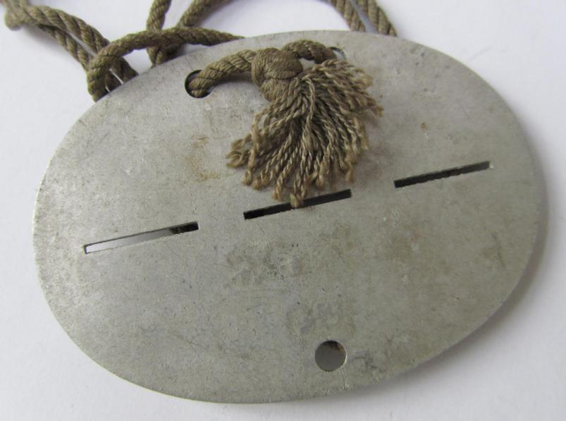 Neat, aluminium-based-, WH (Heeres-) ie. 'Wehrkreis'-related ID-disc, bearing the clearly stamped unit-designation: 'W.Jn.XI' and that comes mounted on its period-attached cord as issued and/or worn
