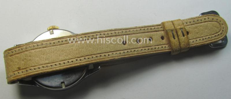 WH (Kriegsmarine) WWII-period wrist-watch (or: 'Dienstuhr') of the make: 'K.M. Siegerin' having a beige-white-coloured dial-plate and neatly engraved number on its back that reads: '328949'