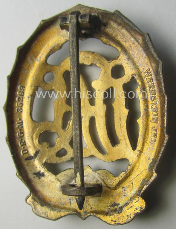 'Reichssportabzeichen DRL in Gold' (or: golden class DRL sports'-badge) being a just moderately worn- ie. used example that is nicely maker- (ie. 'Wernstein - Jena'-) marked on its back