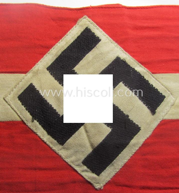 'Standard-issued'-pattern (ie. entirely woven) pattern, bright-red-coloured HJ- (ie. 'Hitlerjugend'-) related armband (ie. 'Armbinde') being a moderately worn- ie. used example that misses its 'RzM'-etiket