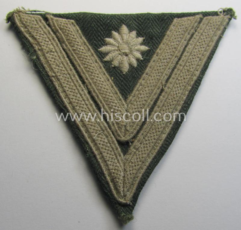 WH (Heeres) 'Armwinkel' (or: arm-chevron) as executed on typical field-grey-coloured (and HBT-type!) linnen as was specifically intended for usage by a soldier with the (unusually encountered!) rank of: 'Stabsgefreiter'