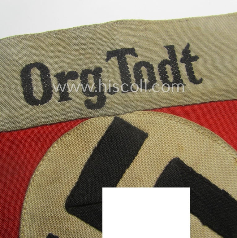 Superb, OT (ie.: 'Organisation Todt') EM- (ie. NCO-) pattern cuff-title (ie. 'Ärmelband für Mannschaften u. Uffz.') combining a swastika- and 'Org.Todt'-cuff-title