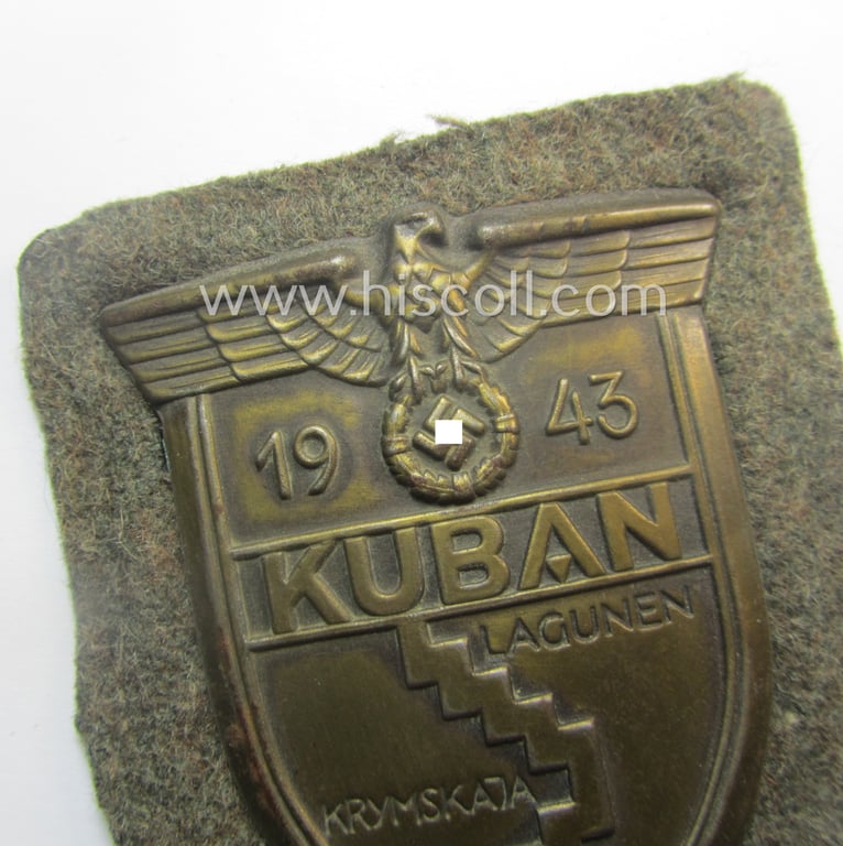 Attractive - truly worn and actually scarcely encountered! - WH (Heeres ie. Waffen-SS) 'Kuban'-campaign-shield that comes mounted onto its original field-grey-coloured- and/or woolen-based 'backing' as issued and/or used