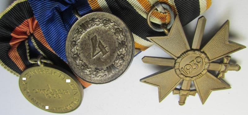 Attractive example of a three-pieced medal-bar (ie.: 'Ordenspange') resp. showing a: 'KvK 2. Klasse mit Schwertern', a: 'WH-DA 4. Stufe' (with firmly attached eagle-device) and a Czech 'Anschluss'-medal '1 Oktober 1938'