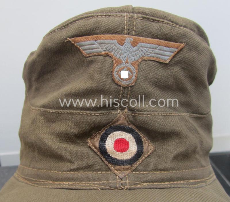 WH (Heeres), 'M41-pattern', tropical-issued field-cap (ie.: 'Tropen-Einheitsfeldmütze') being an (approx.) 57-cms.-sized example that is totally void of a makers'-, date- nor size-designation and that comes in a moderately worn- ie. used, condit...