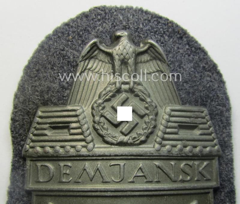 WH (Luftwaffe) 'Demjansk'-campaign-shield as executed in typical magnetic metal (ie. so-called: 'Eisenblech') and that comes in an overall very nice- (ie. still 'virtually mint' ie. fully untouched!), condition