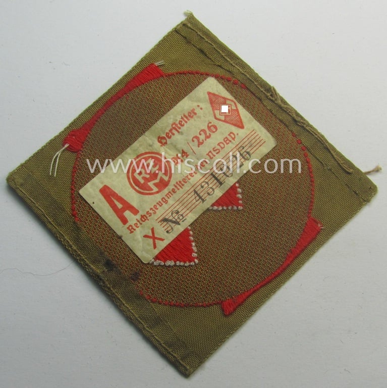 Moderately used, DJ (ie. 'Deutsches Jungvolk') arm-badge as was specifically intended for usage by a member who served within the: 'Oberbann 1' (being a tunic-removed example that still shows its 'RzM'-etiket)