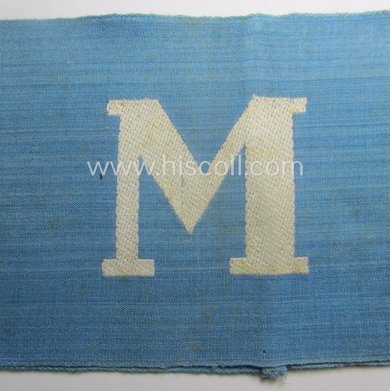 Linnen-based- and/or light-blue-coloured armband (ie. 'Armbinde') depicting an interwoven capital 'W'-character as was presumably intended for staff-members of the RLB (ie. 'Reichsluftschutz-Bund') serving as: 'RLB-Wache' (ie. air-raid-warden guard)