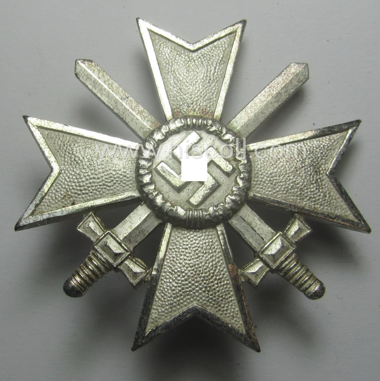 Luxuriously-styled! - 'KvK 1. Klasse mit Schwertern' being an attractive and maker- (ie. '1'-) marked specimen that is executed in typical, silverish-coloured metal (ie. 'Buntmetall') and that comes in a wonderful condition