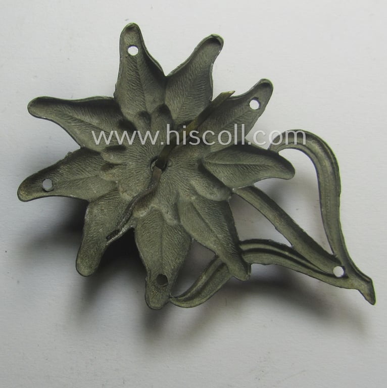 Truly worn (and cap-removed!), WH (Heeres) (darkened) silverish- (ie. golden-) coloured, zinc-based (and non-maker-marked) so-called: 'M43'-pattern 'Edelweiss'-cap-badge (ie. 'Mützenabzeichen')