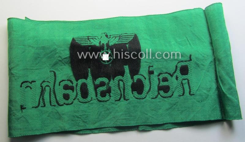 DRB- (ie. 'Deutsche Reichsbahn'-) related armband entitled: 'Reichsbahn' being of the 'entirely-woven'-type onto (typical) silk-like cloth in a technique similar to the 'BeVo'-weave pattern