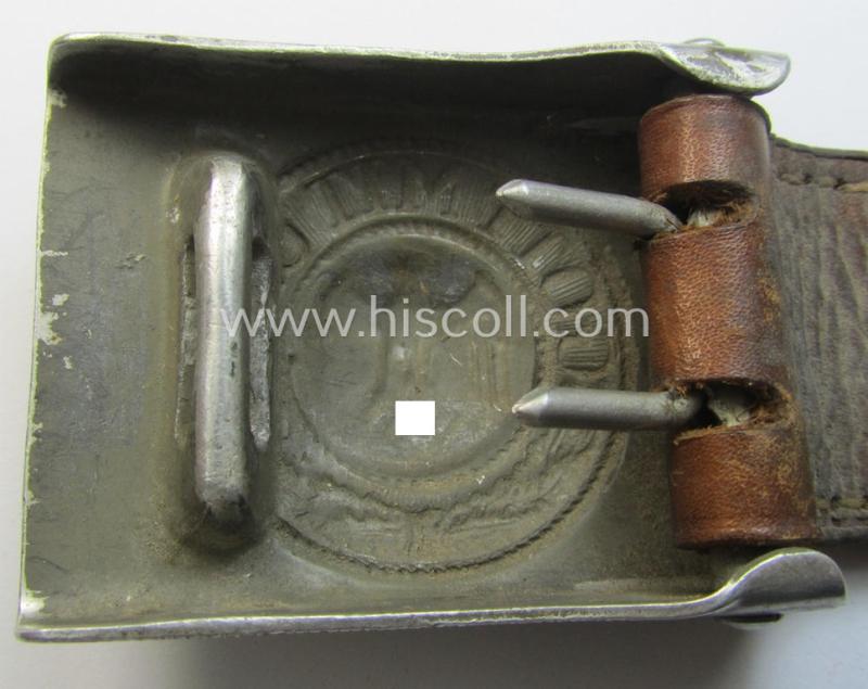 WH (Heeres) 'standard-pattern', field-grey-toned- and aluminium-based belt-buckle being a maker- (I deem 'Bernh. Haarmann'-) marked- and/or '1938'-dated example that comes mounted onto its leather-based tab