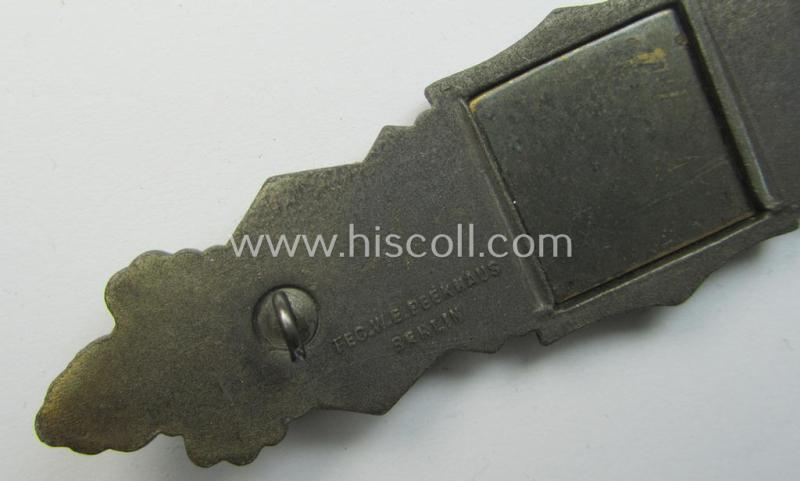 'Nahkampfspange in Bronze' (or: bronze-class close-combat clasp ie. CCC) being a maker- (ie. 'FLL'-) marked- and truly converse-shaped so-called: '3rd pattern'-specimen as was produced by the maker- (ie. 'Hersteller') 'Friedrich Linden'
