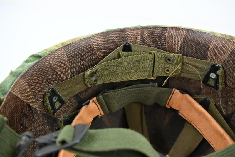 US Vietnam War Infantry helmet with camouflage cover and attached content