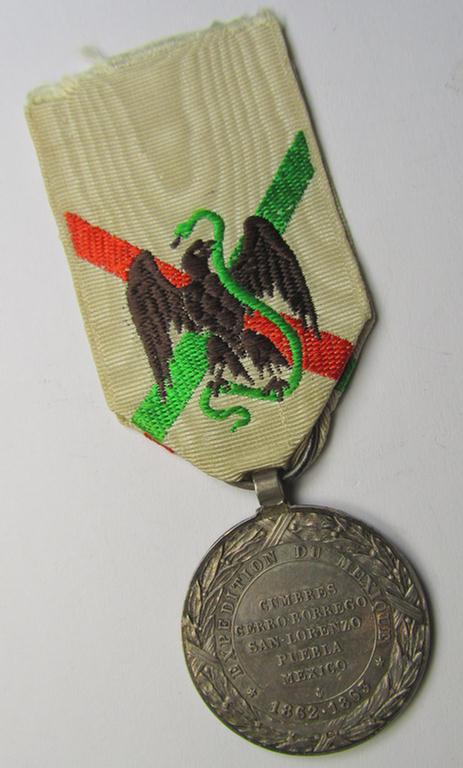 Attractive French, 'Second Empire-period', so-called: 'Expedition to Mexico'-campaign-medal (ie. 'Médaille Commémorative de l'Expédition du Mexique') that comes mounted on its period-ribbon as issued