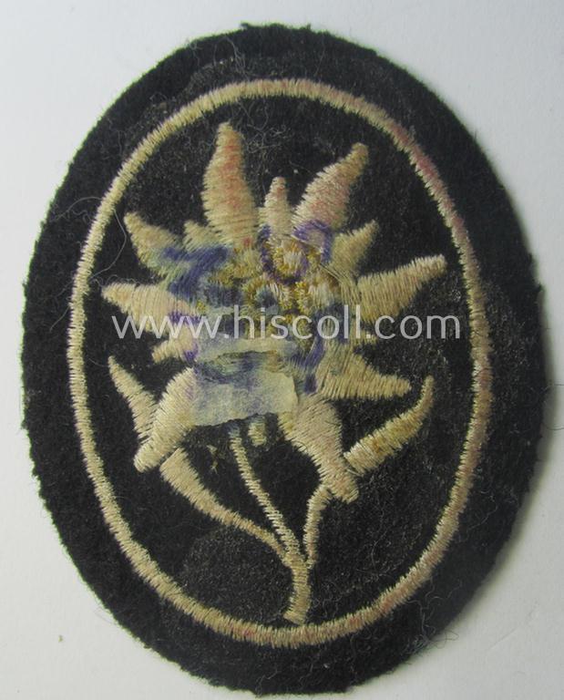 Waffen-SS-pattern, black-coloured sleeve-insignia (ie. 'Ärmelabzeichen') depicting an: 'Edelweiss'-flower as used by the various 'Gebirgsjäger'- (ie. mountain-troops-) related divisional-staff