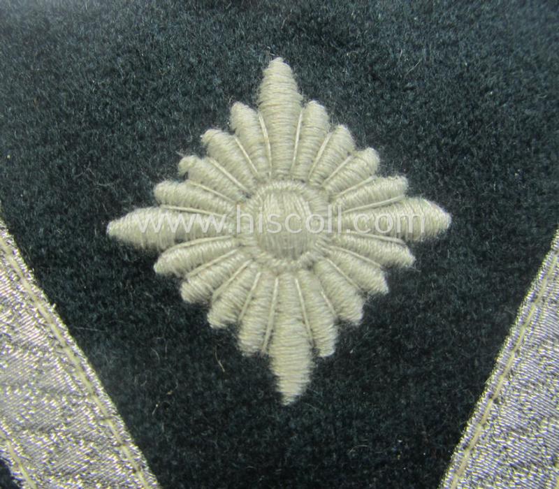 WH (Heeres) 'Armwinkel' (or: arm-chevron) as executed on typical darker-green-coloured wool as was specifically intended for usage by a soldier with the (unusually encountered!) rank of an: 'Gefreiter mit mehr als 6 Dienstjahren'