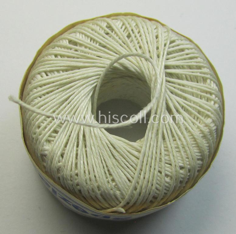 Neat, spare- or soldiers' personal-equipment-item: an unused roll of WH-period stitching-thread holding 50 mtrs. of white-coloured linnen named: 'Spezial Knofzwirn Nr. 30' as was produced by a company named: 'AAK'