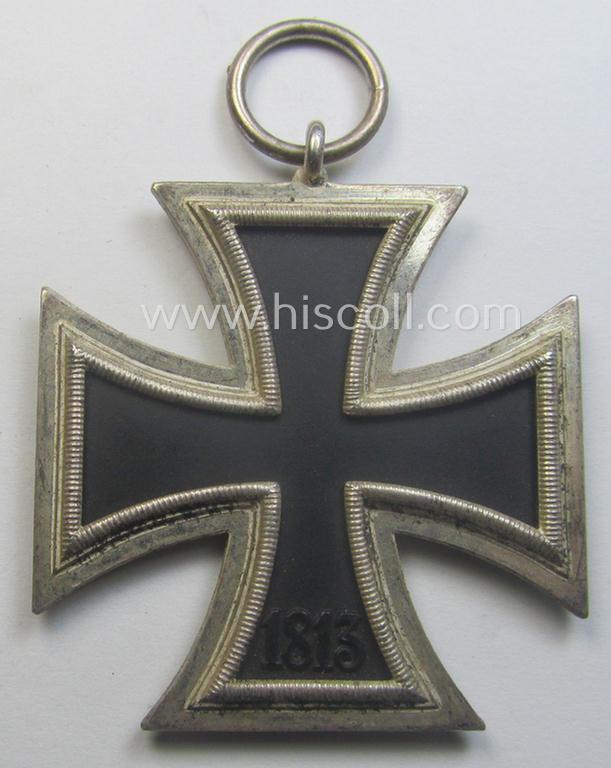 Iron Cross 2nd class (or: 'EK II. Klasse') being a non-maker-marked example that comes together with its original (shortened and orange-red-coloured) ribbon (ie. 'Bandabschnitt') as was produced by the desirable 'C.E. Juncker'-company