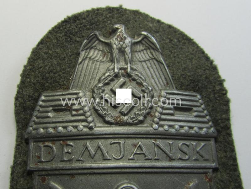 Superb example of a - fairly scarcely encountered! - WH (Heeres ie. Waffen-SS) 'Demjansk'-campaign-shield as executed in typical magnetic metal (ie. so-called: 'Eisenblech') and that comes in an overall very nice- ie. fully untouched, condition