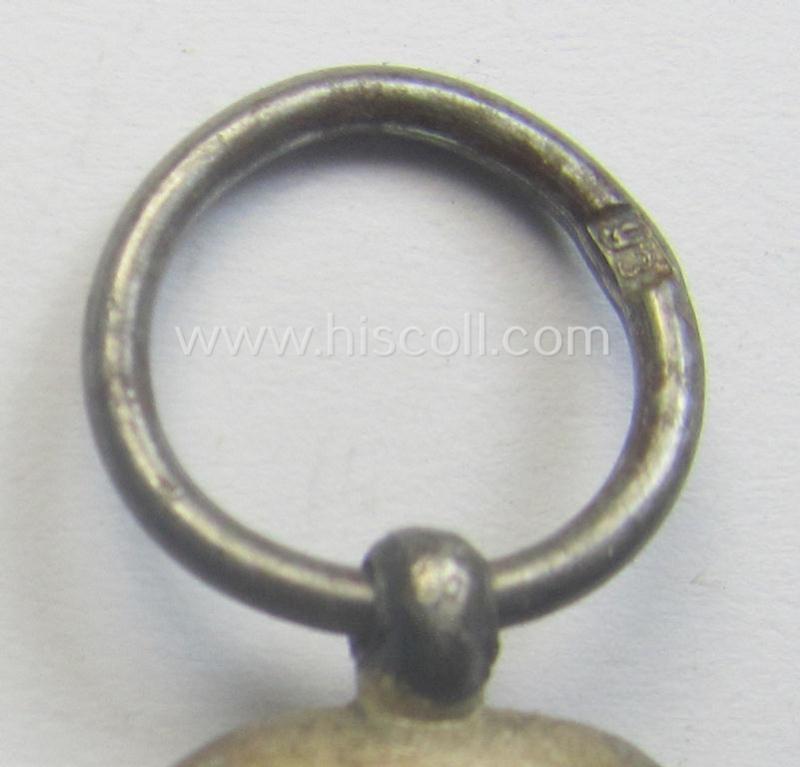 Medal-set: 'Winterschlacht im Osten 1941-42' being a maker- (ie. '93'-) marked- (and/or 'Feinzink'-based) specimen by the maker: 'Richard Simm & Söhne' and that comes together with its (minimally confectioned) ribbon (ie. 'Bandabschnitt')