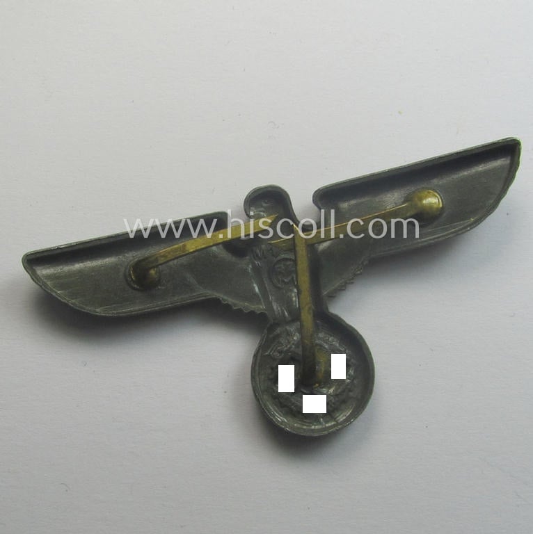 Greyish-silver-coloured- and/or: typical zinc- (ie. 'Feinzink'-) based (political-style) visor- (ie. 'Schirmmützen'-) cap-eagle being a detailed example that is neatly: 'RzM' and/or: 'M1/49' marked on its back