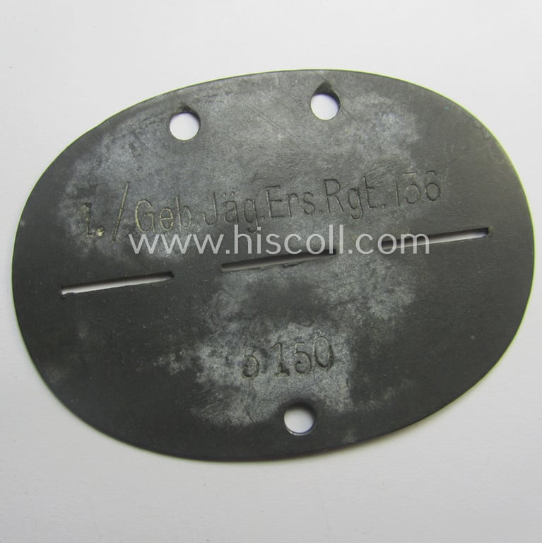Zinc-based, WH (Heeres) 'Gebirgsjäger'-related ID-disc bearing the clearly stamped unit-designation that reads: '1./Geb.Jäg.Ers.Rgt. 136' and that comes as issued and/or worn