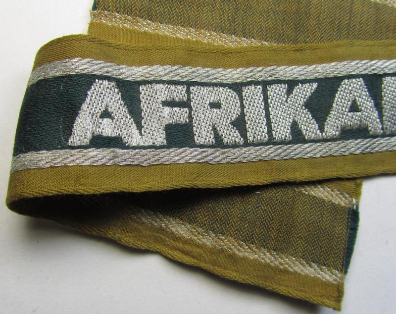 Superb, 'BeVo'-like cuff-title (ie. 'Ärmelstreifen') entitled: 'Afrikakorps' being a with certainty issued and worn example that comes in an overall nice- (ie. minimally shortened- and presumably once tunic-attached-), condition